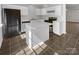Modern kitchen with stainless steel appliances, white cabinets, and a functional center island at 5163 Ficus Tree Ln, Charlotte, NC 28215