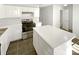 Well-lit kitchen features stainless steel appliances, central island and white cabinets at 5163 Ficus Tree Ln, Charlotte, NC 28215