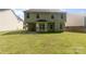 A lush backyard featuring a well-maintained lawn, a patio, and the rear exterior of a two-story home at 5233 Halverson Ct, Kannapolis, NC 28083