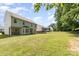 Expansive backyard with lush green lawn featuring the rear of the home and mature trees in the landscape at 5233 Halverson Ct, Kannapolis, NC 28083