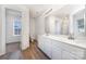 Bright bathroom showcasing double sink vanity and ample storage; attached is a well-lit walk-in closet at 5233 Halverson Ct, Kannapolis, NC 28083