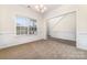 Bright dining room with large window, plush carpet, and an elegant chandelier for a warm ambiance at 5233 Halverson Ct, Kannapolis, NC 28083