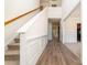 Inviting entryway with beautiful staircase, hardwood floors, and stylish wainscoting at 5233 Halverson Ct, Kannapolis, NC 28083