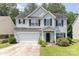 Charming two-story home featuring an attached garage, manicured lawn, and a welcoming entrance at 5233 Halverson Ct, Kannapolis, NC 28083