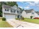 Traditional two-story home with a long driveway, attached garage, and manicured lawn at 5233 Halverson Ct, Kannapolis, NC 28083