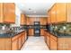 Well-equipped kitchen with wood cabinets, black appliances, and a stylish backsplash at 5233 Halverson Ct, Kannapolis, NC 28083