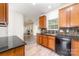 Functional kitchen with wood cabinets, granite countertops, and a view into the living room at 5233 Halverson Ct, Kannapolis, NC 28083