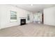 Spacious living room with plush carpet, fireplace, and ample natural light from large windows at 5233 Halverson Ct, Kannapolis, NC 28083