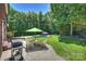 Cozy backyard patio with outdoor seating and grill, great for enjoying summer evenings with friends and Gathering at 6309 Chamar Cir, Kannapolis, NC 28081