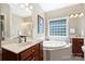 A bathroom with double sinks, a large soaking tub, and a tile surround at 6309 Chamar Cir, Kannapolis, NC 28081