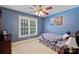 Inviting bedroom featuring a large window, soft lighting, and blue painted walls at 6309 Chamar Cir, Kannapolis, NC 28081