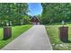 Long driveway leading to a brick home, showcasing curb appeal and ample parking at 6309 Chamar Cir, Kannapolis, NC 28081