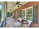 Charming front porch with brick flooring, white columns, and comfortable seating at 6309 Chamar Cir, Kannapolis, NC 28081