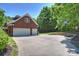 Three car garage with basketball hoop and driveway, providing ample parking and recreational space at 6309 Chamar Cir, Kannapolis, NC 28081