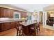 A kitchen featuring wood cabinets, granite countertops, stainless steel appliances, and a large island with seating at 6309 Chamar Cir, Kannapolis, NC 28081