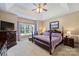 A bedroom with a four-poster bed, a window with natural light, and an ensuite bathroom at 6309 Chamar Cir, Kannapolis, NC 28081