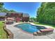 Inviting in-ground pool with brick surround and adjacent patio area for relaxing and enjoying the outdoors at 6309 Chamar Cir, Kannapolis, NC 28081