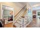 Carpeted stairway with wood handrails and white spindles connecting different levels of the home at 6309 Chamar Cir, Kannapolis, NC 28081