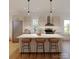 Bright kitchen with modern appliances, an island with bar stool seating, and pendant lighting at 724 Drakeford Ct, Charlotte, NC 28216