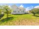 Wide backyard with healthy green grass, a deck, landscaping, and privacy at 7737 Pleasant Valley Dr, Harrisburg, NC 28075