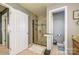 Bright bathroom featuring a glass shower, neutral tile, and granite vanity at 7737 Pleasant Valley Dr, Harrisburg, NC 28075