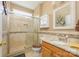 Bathroom featuring tiled shower, modern sink, and decorative mirror at 7737 Pleasant Valley Dr, Harrisburg, NC 28075