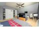 Bonus room with desk, TV, and couch; good for a game or movie room at 7737 Pleasant Valley Dr, Harrisburg, NC 28075
