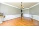 Hardwood floors, neutral paint and wainscotting create an elegant dining space at 7737 Pleasant Valley Dr, Harrisburg, NC 28075
