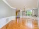 Formal dining room features hardwood floors, elegant trim, and chandelier at 7737 Pleasant Valley Dr, Harrisburg, NC 28075