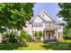 Charming two-story home featuring a well-manicured lawn and beautifully landscaped front yard at 7737 Pleasant Valley Dr, Harrisburg, NC 28075