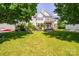 A spacious front yard with lush green grass and a charming two-story home in the background at 7737 Pleasant Valley Dr, Harrisburg, NC 28075