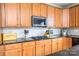 The Kitchen has overhead microwave, gas cooktop, and granite countertops at 7737 Pleasant Valley Dr, Harrisburg, NC 28075
