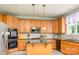 The Kitchen has a center island, double wall oven, and natural wood cabinets at 7737 Pleasant Valley Dr, Harrisburg, NC 28075