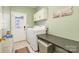 A compact laundry room with a modern washer and dryer and storage at 7737 Pleasant Valley Dr, Harrisburg, NC 28075