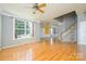 Spacious living room with hardwood floors, neutral paint, and large window at 7737 Pleasant Valley Dr, Harrisburg, NC 28075