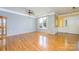 Hardwood floors, neutral paint and large window illuminate a spacious living room at 7737 Pleasant Valley Dr, Harrisburg, NC 28075