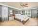 Spacious main bedroom featuring a bed, two windows, and a ceiling fan at 7737 Pleasant Valley Dr, Harrisburg, NC 28075