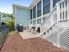 Cozy backyard patio with rocking chairs and a grill for outdoor entertaining at 8918 Cotton Press Rd, Charlotte, NC 28277