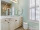 Well-lit bathroom with a large mirror, white cabinets, and tiled floors at 8918 Cotton Press Rd, Charlotte, NC 28277