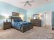 Comfortable bedroom featuring blue walls, plush carpet, and light gray furniture at 8918 Cotton Press Rd, Charlotte, NC 28277