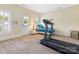 Bright room with a treadmill, a daybed, and plantation shutters at 8918 Cotton Press Rd, Charlotte, NC 28277