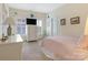 Bedroom featuring white dresser, shuttered window, and pink accents at 8918 Cotton Press Rd, Charlotte, NC 28277