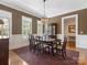 Formal dining room with a chandelier, hardwood floors, and a large window at 8918 Cotton Press Rd, Charlotte, NC 28277