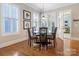 Elegant dining room with shuttered windows, natural lighting, and rich wood flooring at 8918 Cotton Press Rd, Charlotte, NC 28277