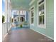 Relaxing covered porch featuring rocking chairs, a ceiling fan, and views of the neighborhood at 8918 Cotton Press Rd, Charlotte, NC 28277
