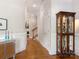 Spacious hallway with hardwood floors, white trim, and a display cabinet at 8918 Cotton Press Rd, Charlotte, NC 28277