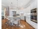 Contemporary kitchen with a spacious island, double oven, and hardwood flooring at 8918 Cotton Press Rd, Charlotte, NC 28277