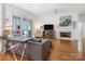 Cozy living room with a fireplace, hardwood floors, and a view of the outdoor patio at 8918 Cotton Press Rd, Charlotte, NC 28277