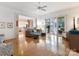 Open living room featuring hardwood floors, neutral decor, and a seamless flow to the kitchen and patio at 8918 Cotton Press Rd, Charlotte, NC 28277