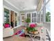 Beautifully lit sun room with a comfortable seating area and multiple windows at 8918 Cotton Press Rd, Charlotte, NC 28277